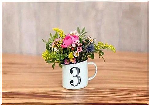 Metal cup with flowers