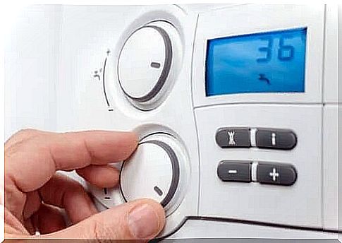 Person adjusting a thermostat