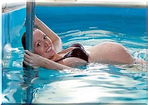 Pregnant woman swimming in the pool