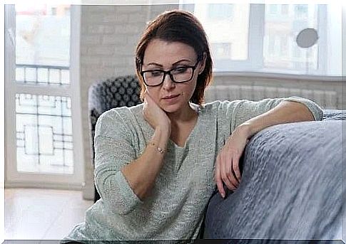 Sad woman sitting on the couch