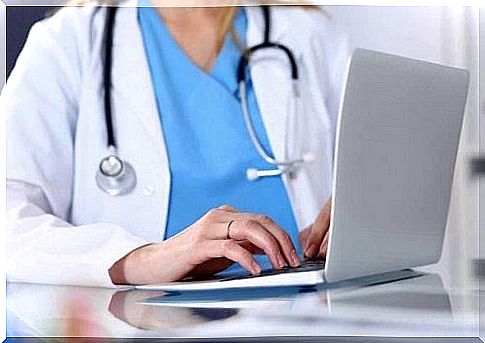 Doctor typing on laptop