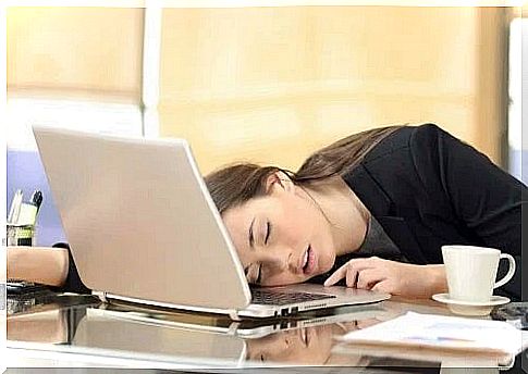 Girl sleeping with her head on the laptop